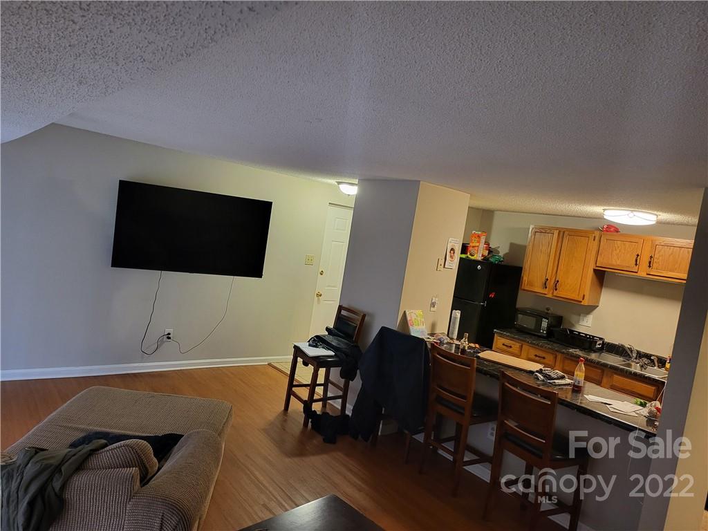 9405 Old Concord Road, Unit D Charlotte, NC 28213 - Photo 9 of 17 a room with furniture and flat screen tv