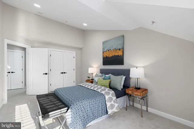 a bedroom with furniture and a lamp