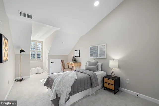 a bedroom with bed and a night stand