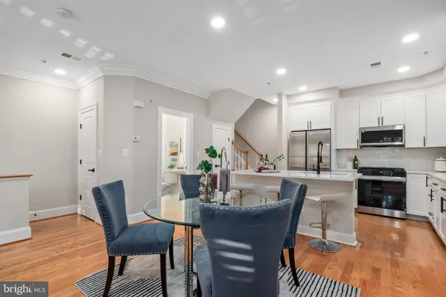 a dining room with furniture and wooden floor