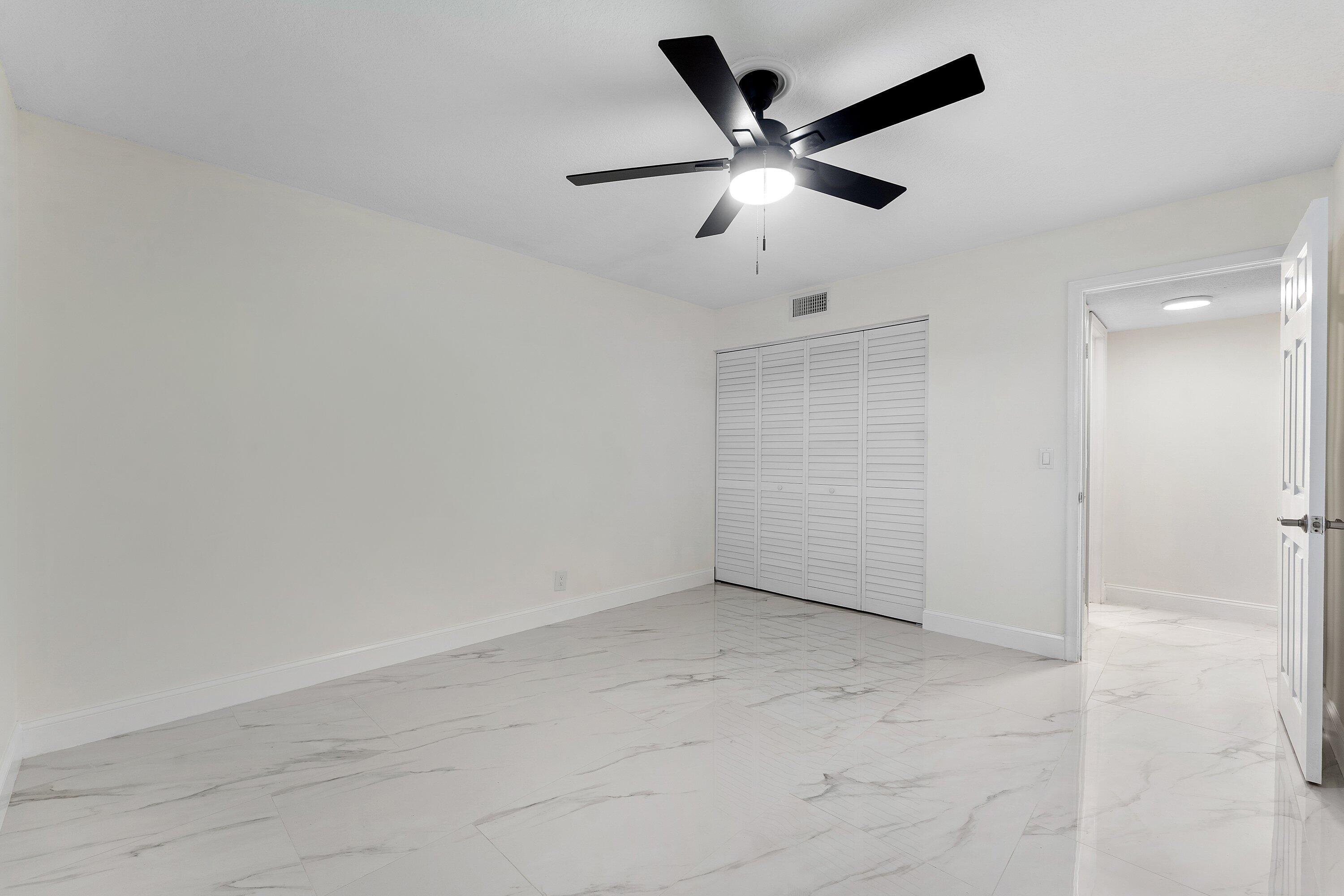 9911 Sandalfoot Boulevard, Unit 113 Boca Raton, FL 33428 - Photo 14 of 19 wooden floor in an empty room