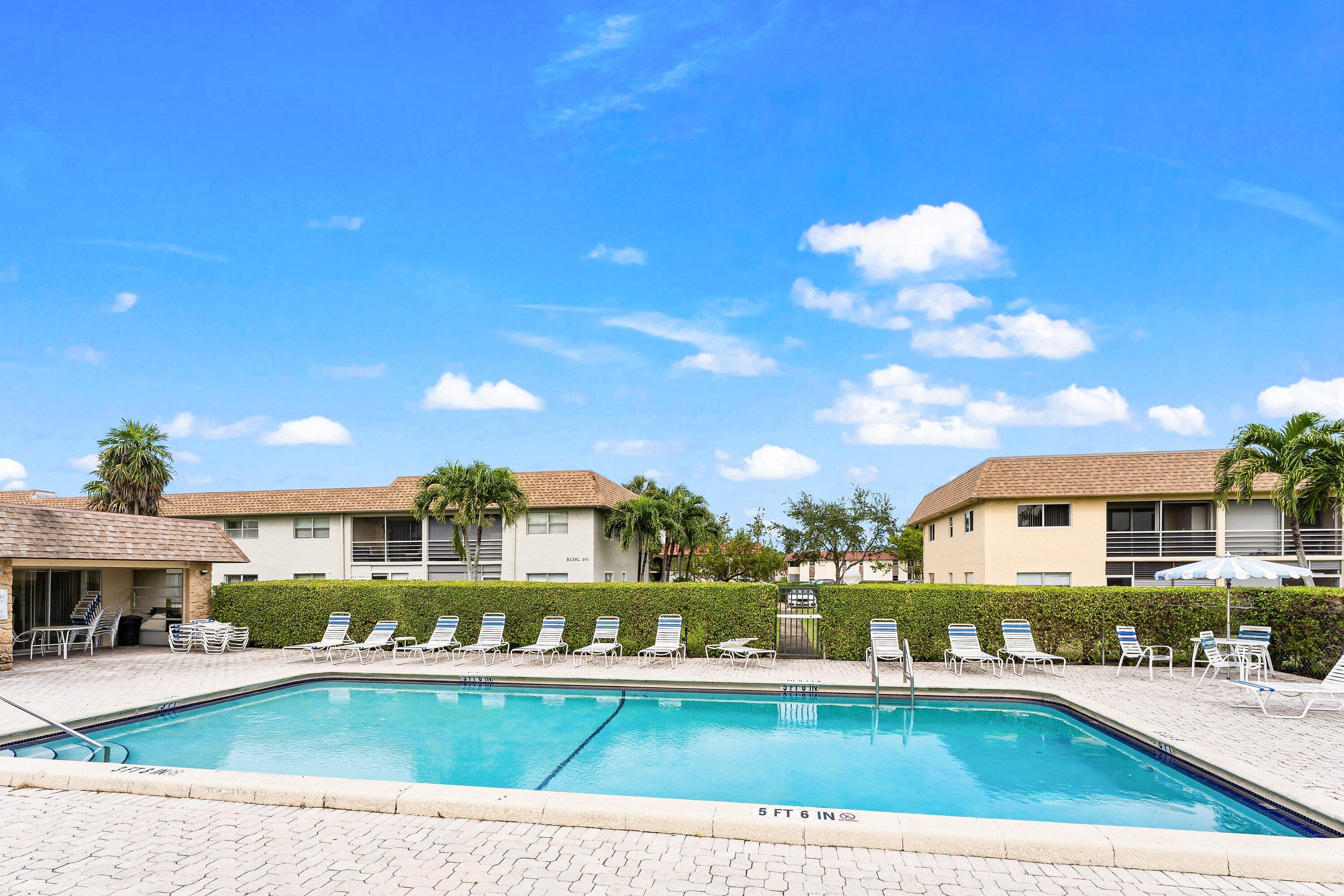 9911 Sandalfoot Boulevard, Unit 113 Boca Raton, FL 33428 - Photo 18 of 19 a view of swimming pool with outdoor seating