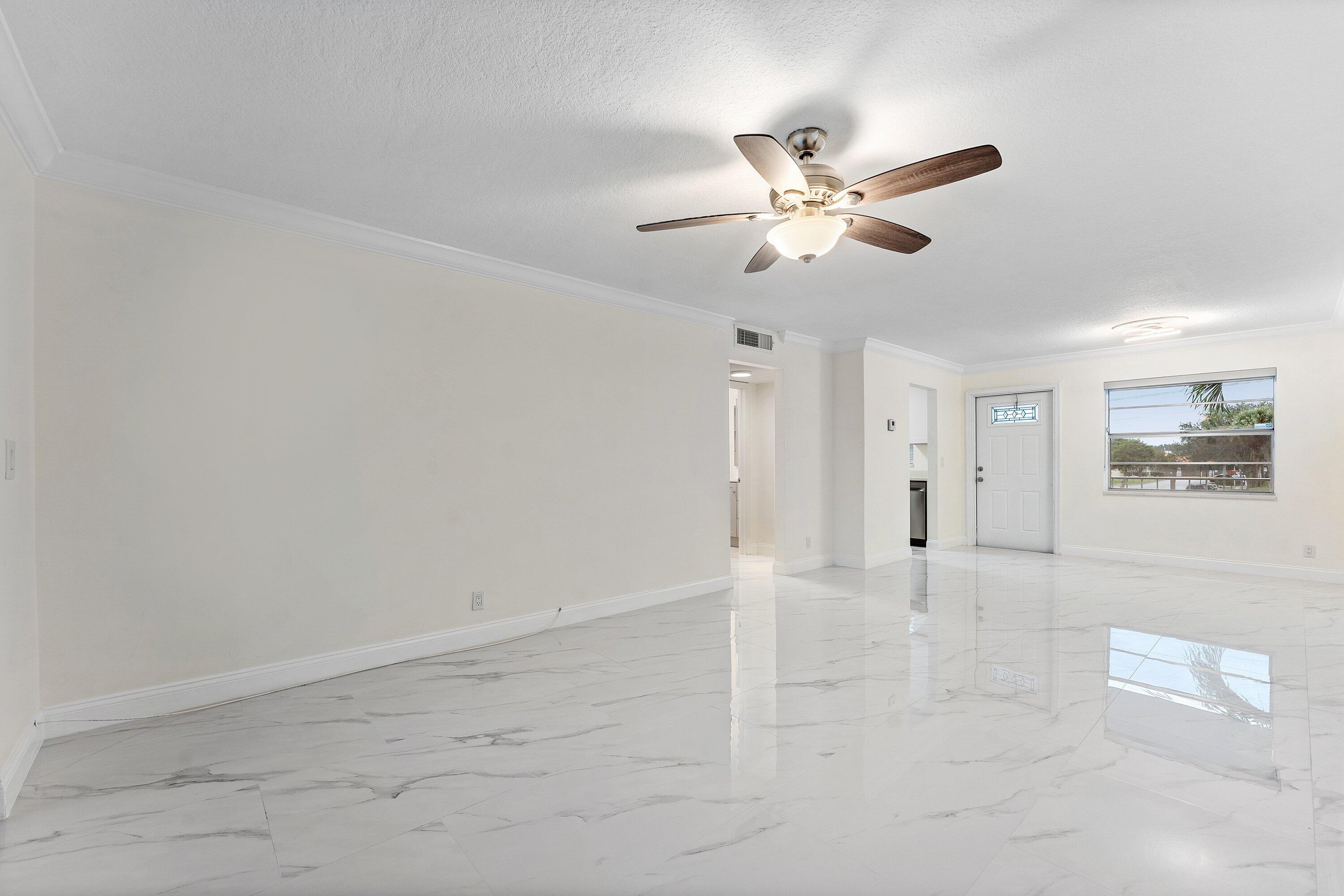 9911 Sandalfoot Boulevard, Unit 113 Boca Raton, FL 33428 - Photo 9 of 19 a view of an empty room