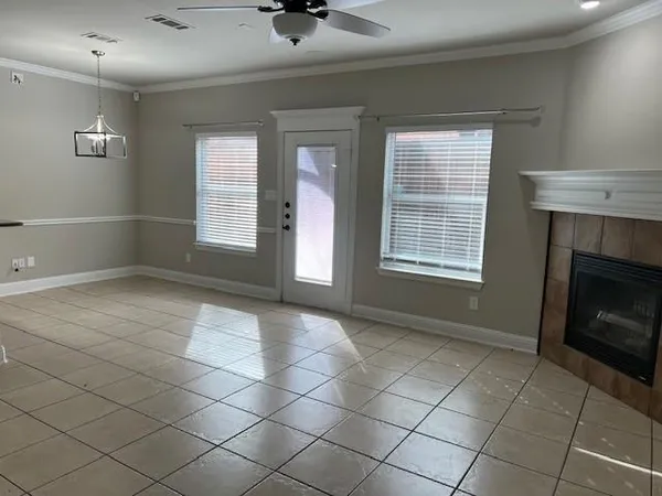 a view of an empty room with a fireplace and a window