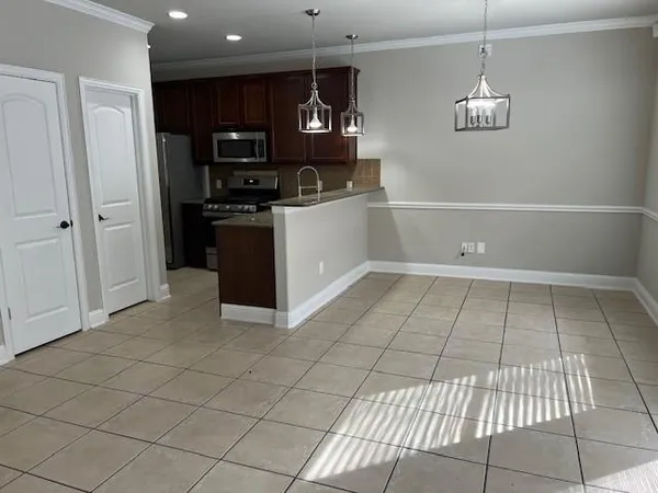a kitchen with stainless steel appliances a refrigerator and a counter top space