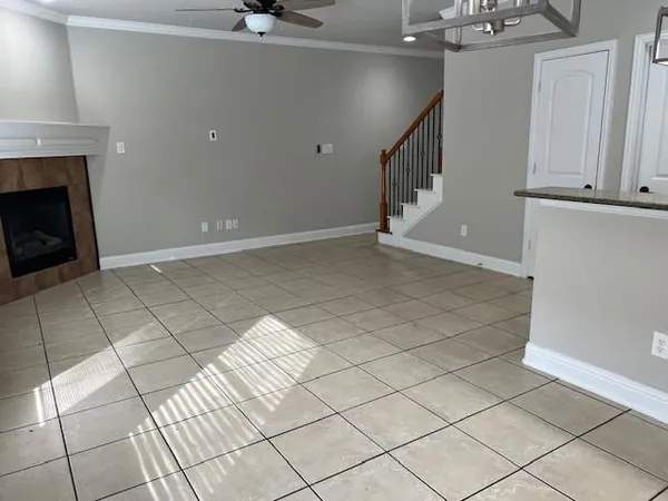 a view of an empty room with staircase