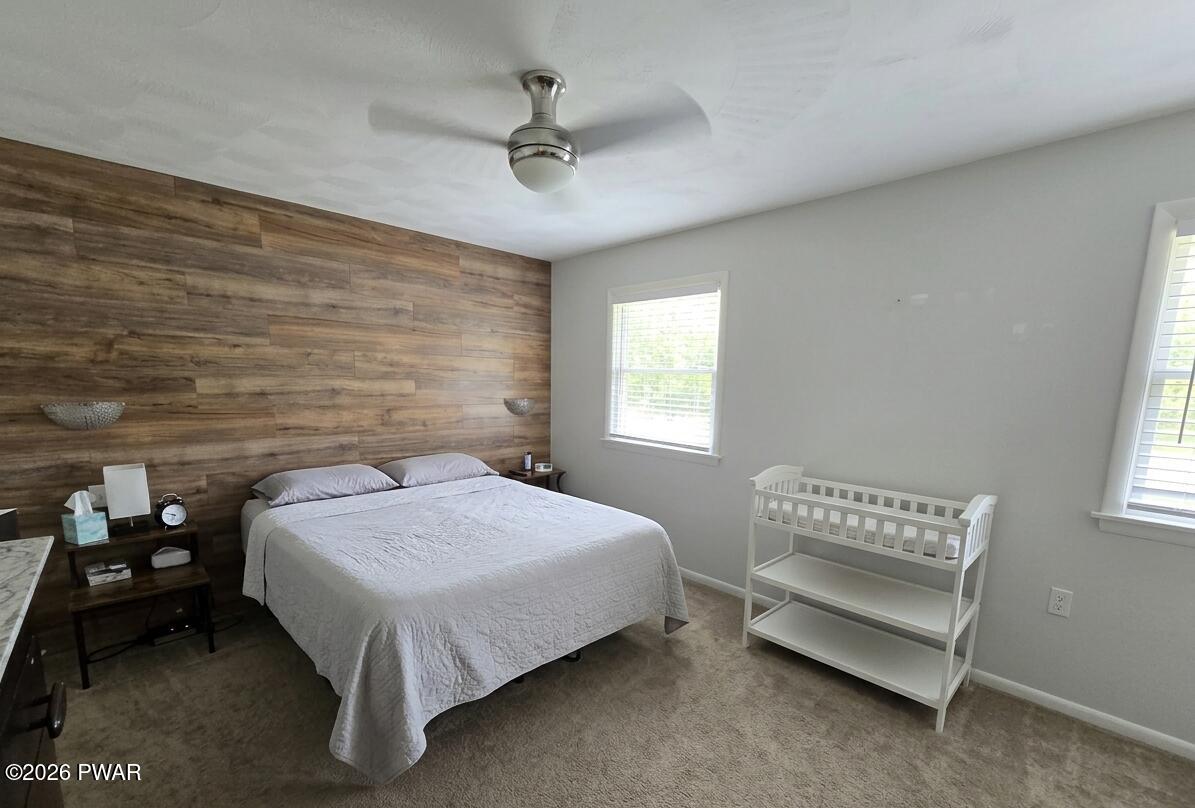 107 Keystone Hls Road, Unit 404 Factoryville, PA 18419 - Photo 12 of 23 a bedroom with a bed and a window