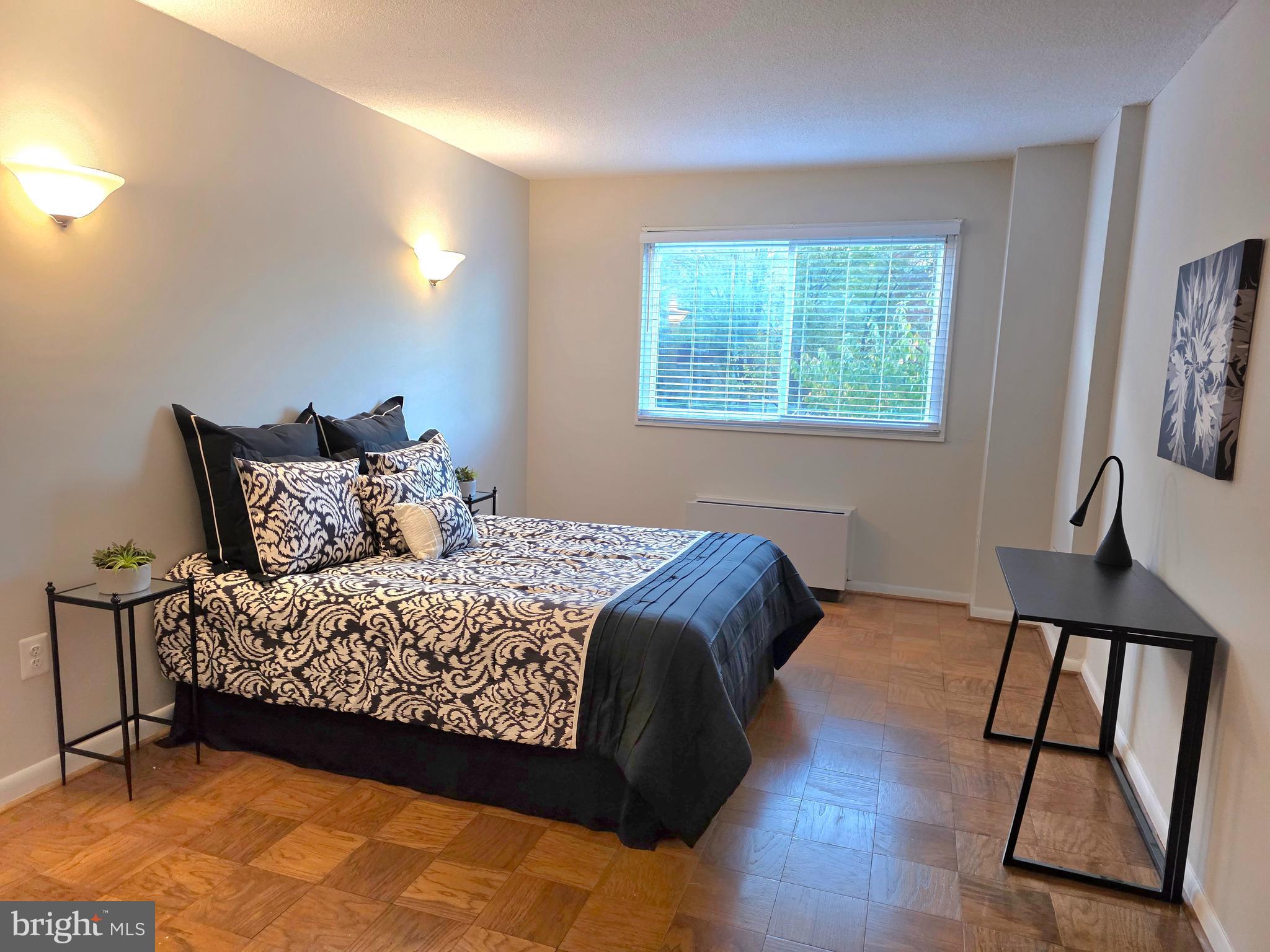 2059 Huntington Avenue, Unit 312 Alexandria, VA 22303 - Photo 13 of 33 a bed sitting in a bedroom next to a window