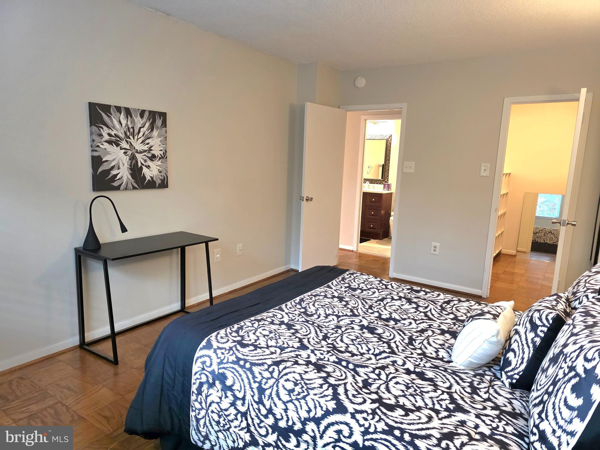 2059 Huntington Avenue, Unit 312 Alexandria, VA 22303 - Photo 14 of 33 a bedroom with a bed and wooden floor