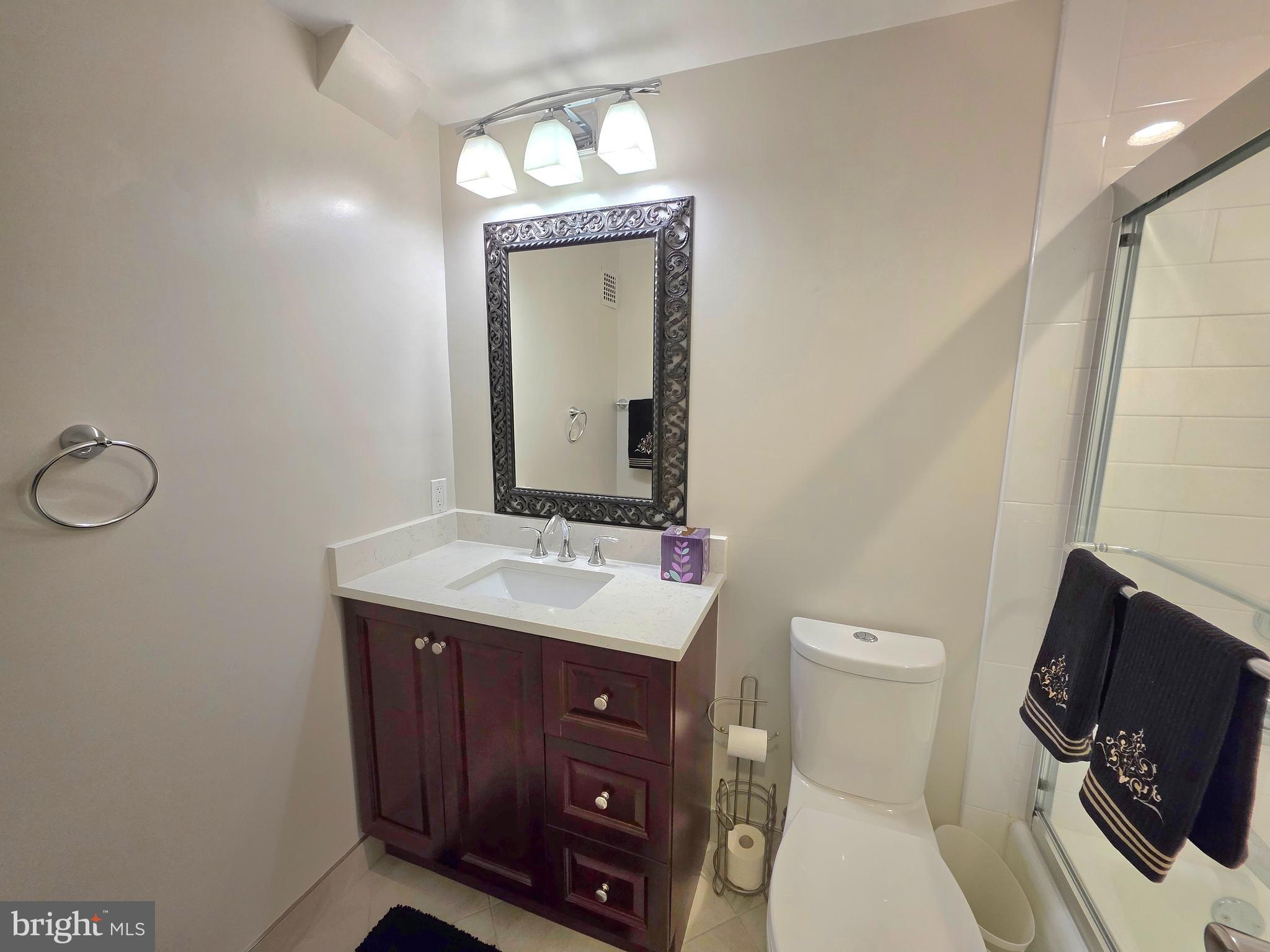 2059 Huntington Avenue, Unit 312 Alexandria, VA 22303 - Photo 16 of 33 a bathroom with a toilet sink and mirror