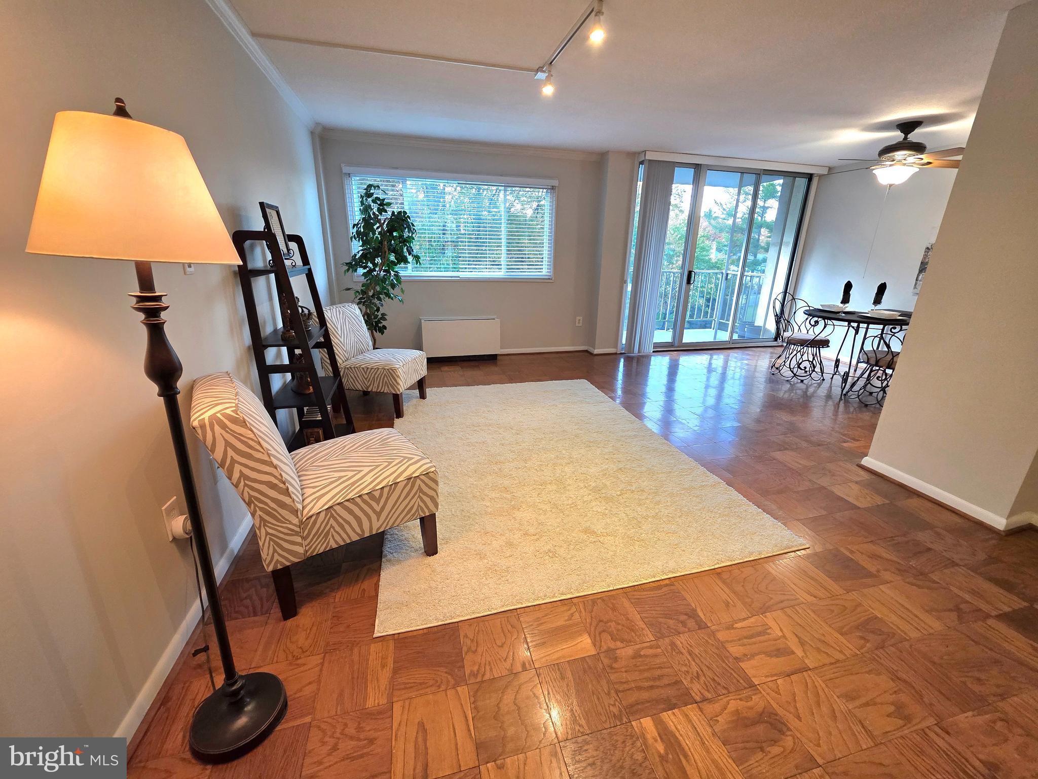 2059 Huntington Avenue, Unit 312 Alexandria, VA 22303 - Photo 2 of 33 a living room with furniture and a lamp