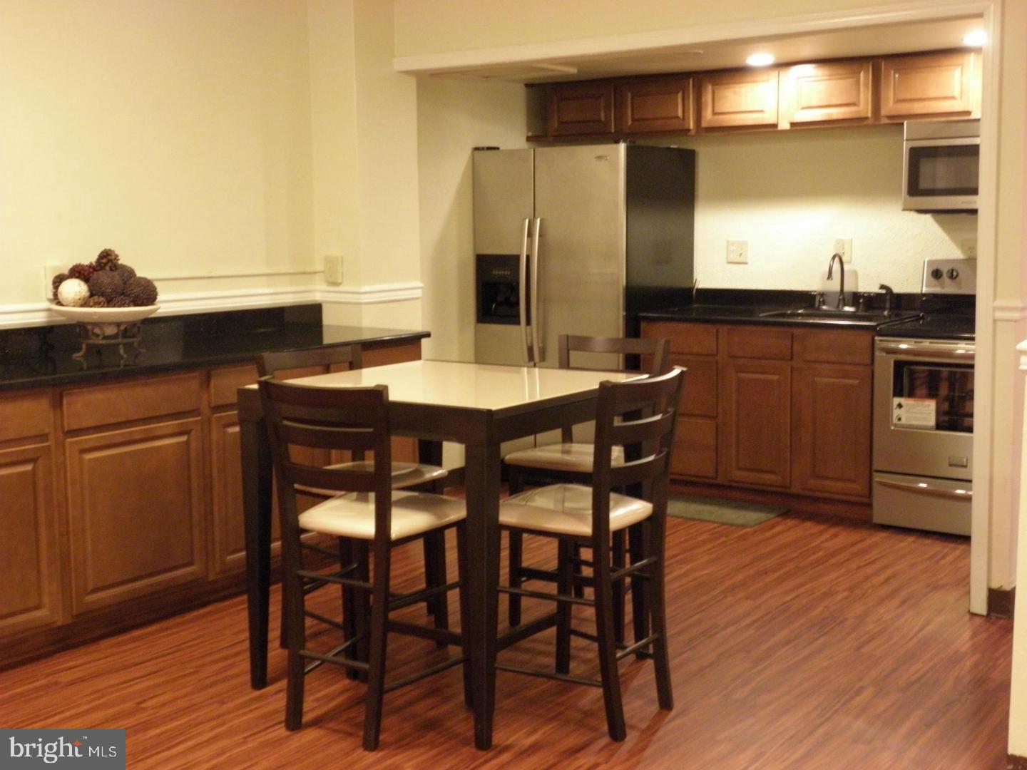 2059 Huntington Avenue, Unit 312 Alexandria, VA 22303 - Photo 27 of 33 a kitchen with a table and chairs in it