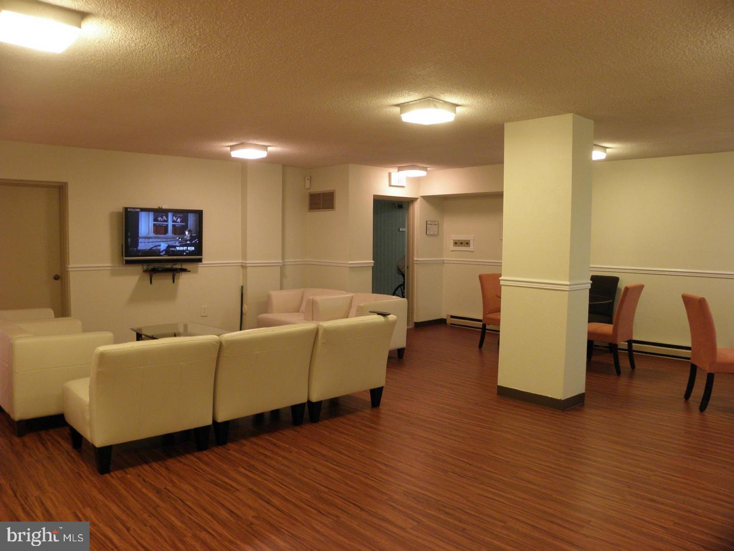 2059 Huntington Avenue, Unit 312 Alexandria, VA 22303 - Photo 28 of 33 a living room with furniture and a wooden floor