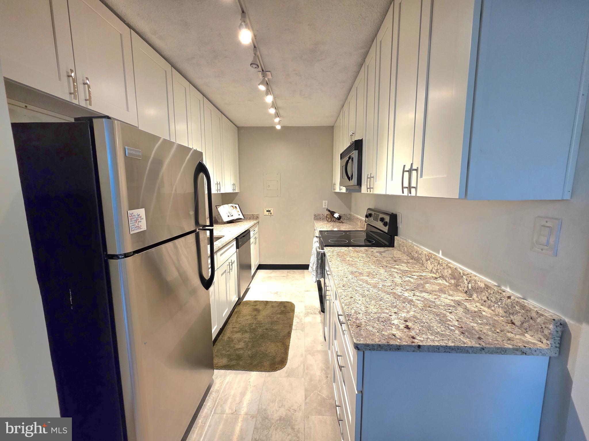 2059 Huntington Avenue, Unit 312 Alexandria, VA 22303 - Photo 6 of 33 a kitchen with granite countertop a refrigerator and a sink