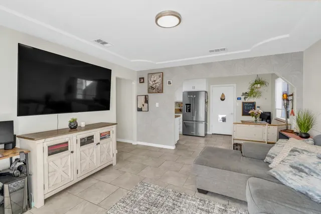 a view of a livingroom with furniture and a flat screen tv