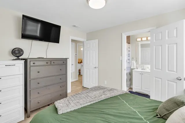 a bedroom with a bed and a window