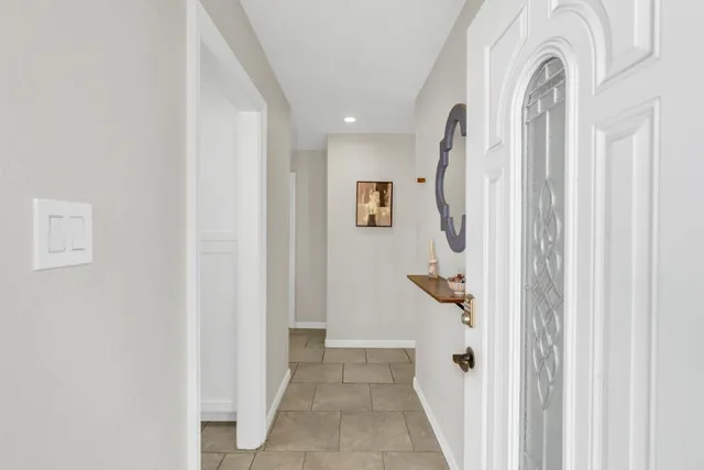 a view of a livingroom with wooden floor and entryway