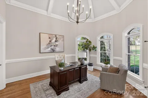 a view of a patio with table and chairs with wooden floor and fence