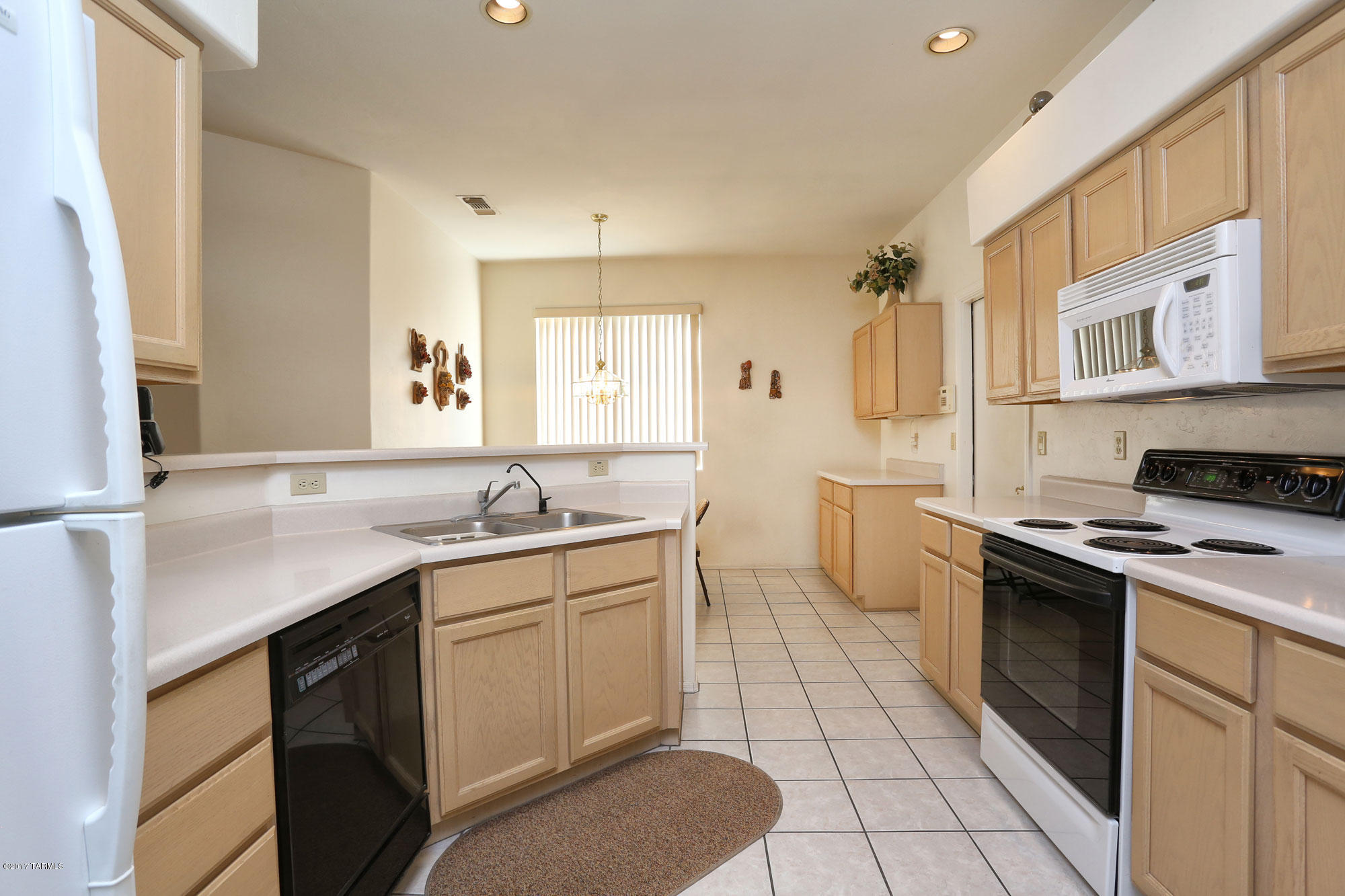 9182 East Dawn Post Road Tucson, AZ 85749 - Photo 8 of 25 a kitchen with a sink stove and cabinets