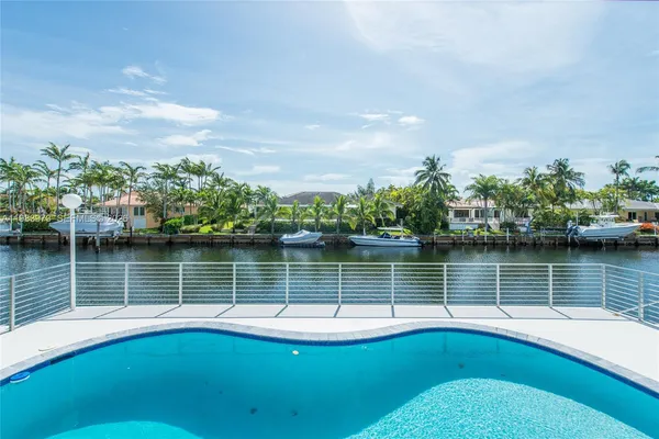 a view of swimming pool with a lake and a nearby room