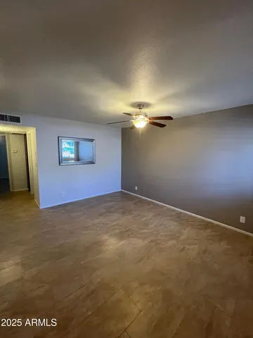a kitchen with cabinets and a refrigerator