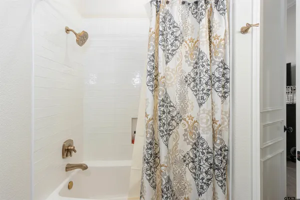 a bathroom with a shower and a bathtub
