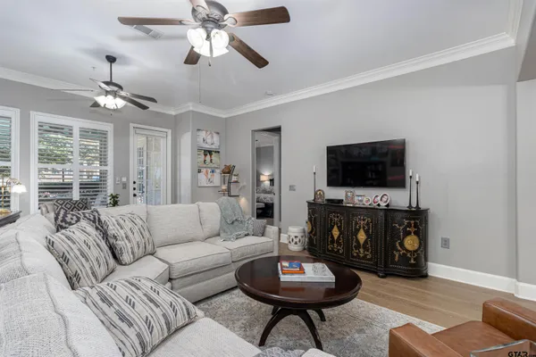 a living room with furniture a fireplace and a flat screen tv