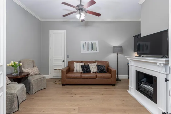 a living room with furniture a fireplace and a flat screen tv