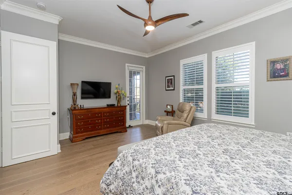 a bedroom with furniture and a flat screen tv