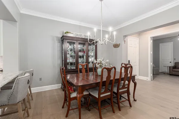 a view of a dining room with furniture and chandelier