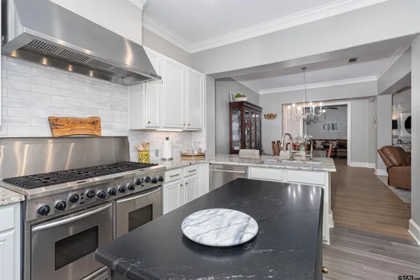 a kitchen with a stove a sink and a stove