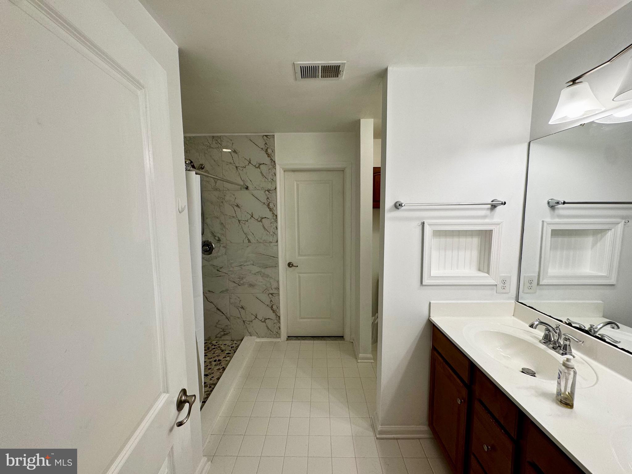 2223 Argonne Drive Havre de Grace, MD 21078 - Photo 16 of 29 a spacious bathroom with a shower sink and mirror