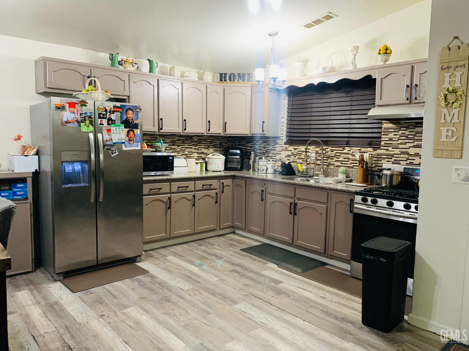 Undisclosed Address Delano, CA 93215 - Photo 6 of 14 a kitchen with stainless steel appliances granite countertop a sink stove and refrigerator