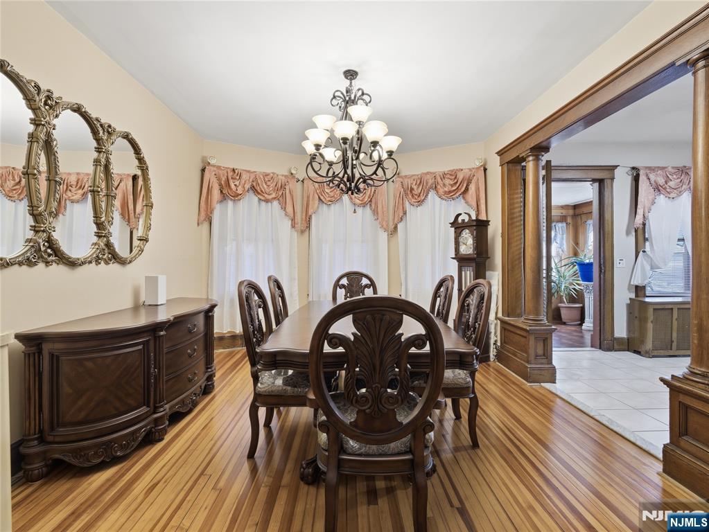 768 East 25th Street Paterson, NJ 07504 - Photo 13 of 29 a view of a dining room with furniture a chandelier and wooden floor