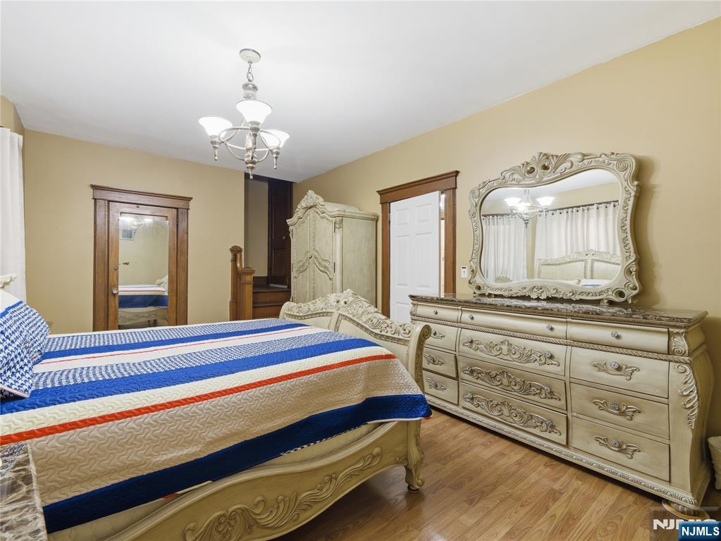 768 East 25th Street Paterson, NJ 07504 - Photo 27 of 29 a spacious bedroom with a bed and a dresser