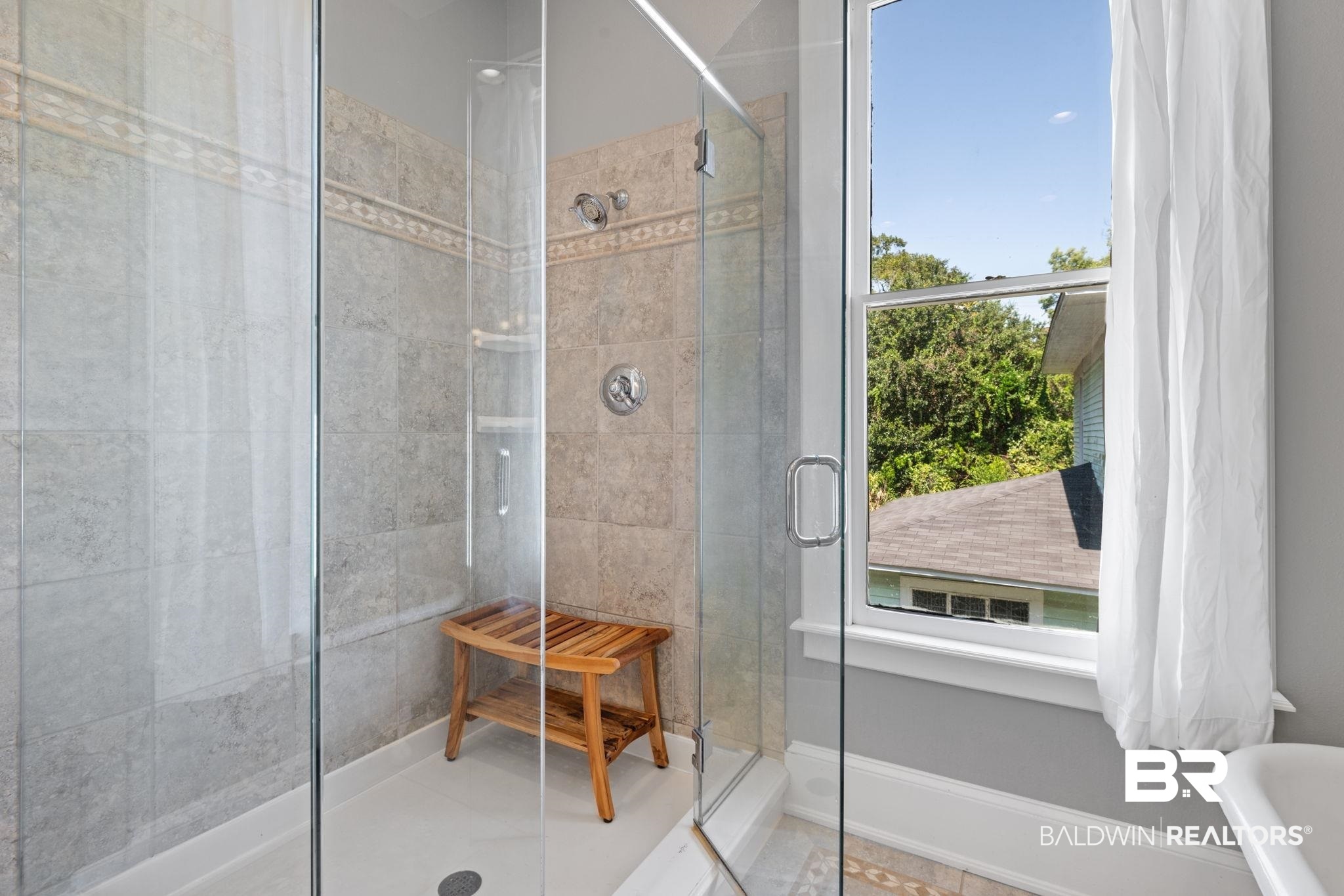 10 South Monterey Street Mobile, AL 36604 - Photo 24 of 45 Full bathroom featuring a walk in shower, a freestanding tub, and tile patterned flooring