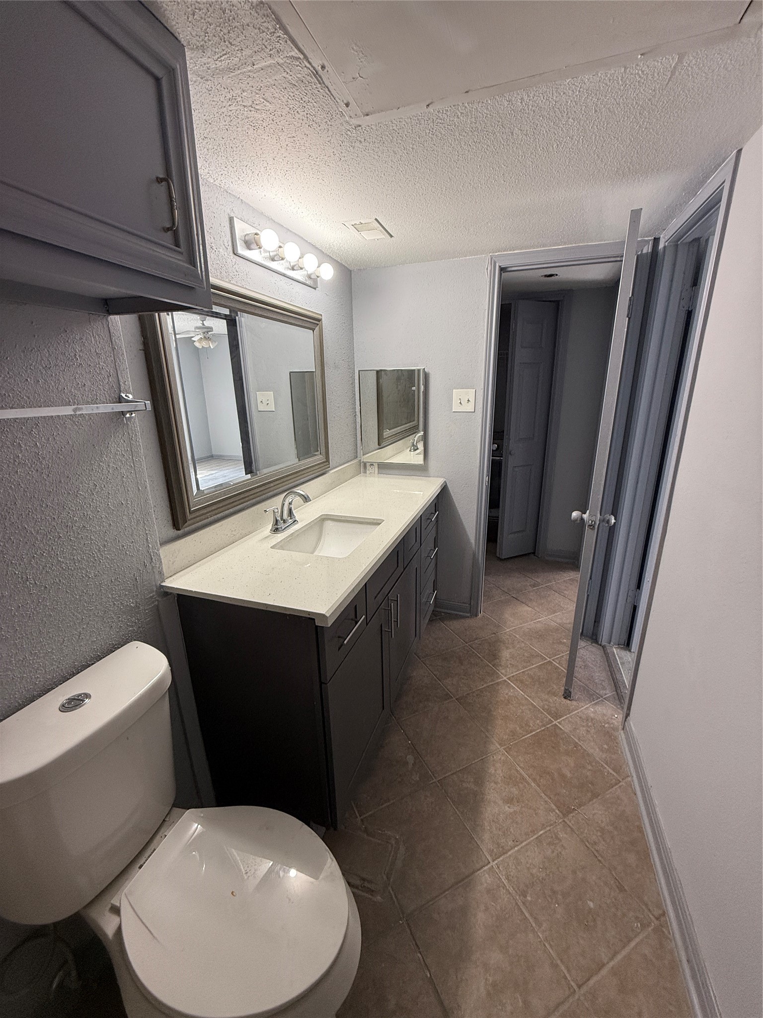 12200 Overbrook Lane, Unit 34D Houston, TX 77077 - Photo 11 of 19 a bathroom with a toilet sink and mirror
