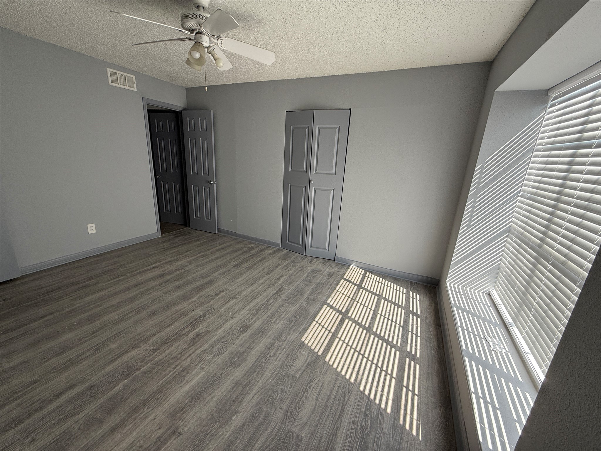 12200 Overbrook Lane, Unit 34D Houston, TX 77077 - Photo 12 of 19 wooden floor in an empty room with a window
