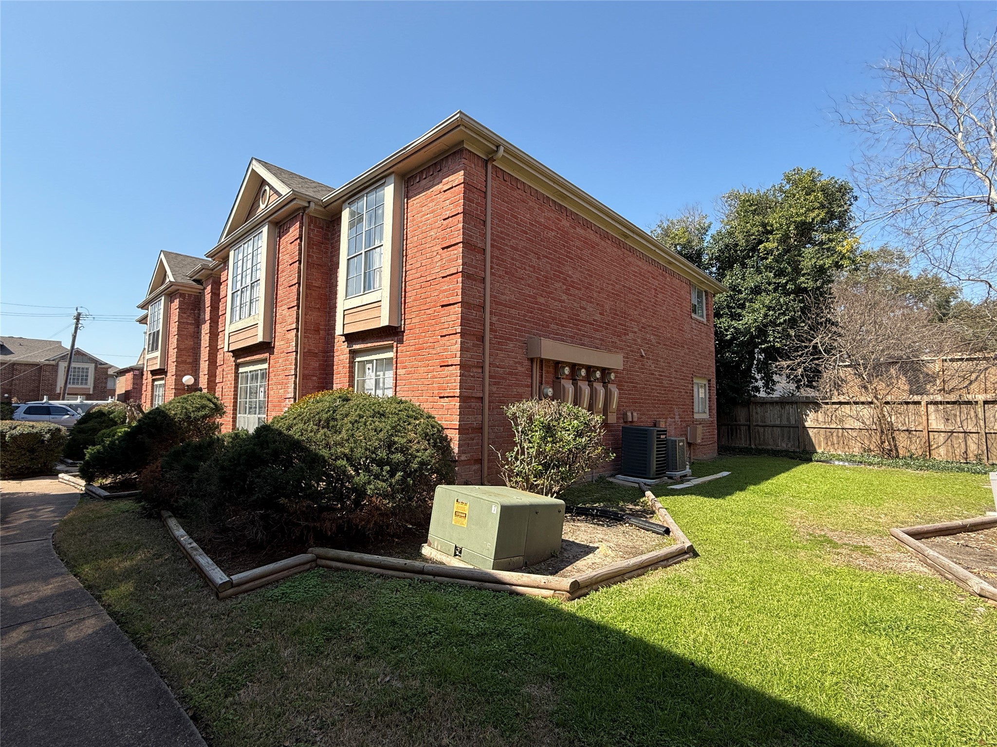 12200 Overbrook Lane, Unit 34D Houston, TX 77077 - Photo 19 of 19 a front view of a house with garden and trees