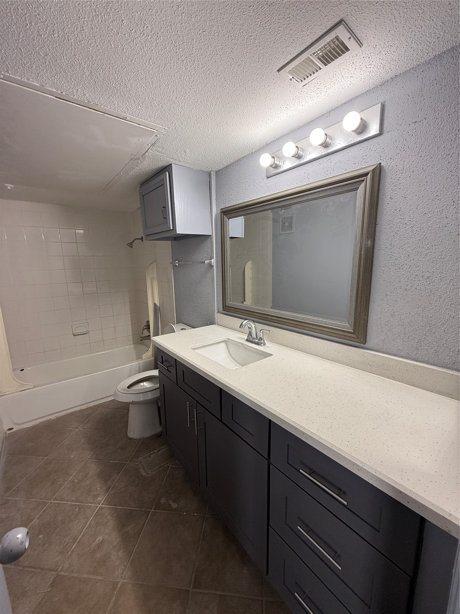12200 Overbrook Lane, Unit 34D Houston, TX 77077 - Photo 10 of 19 a bathroom with a sink a toilet a mirror and shower