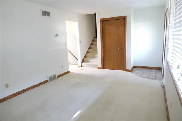 a kitchen with stainless steel appliances granite countertop a refrigerator a stove and a sink with wooden floor