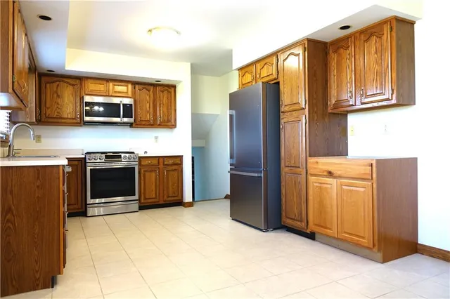 a kitchen with stainless steel appliances granite countertop a sink stove and cabinets