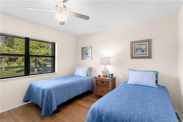 a bedroom with two beds and a large window