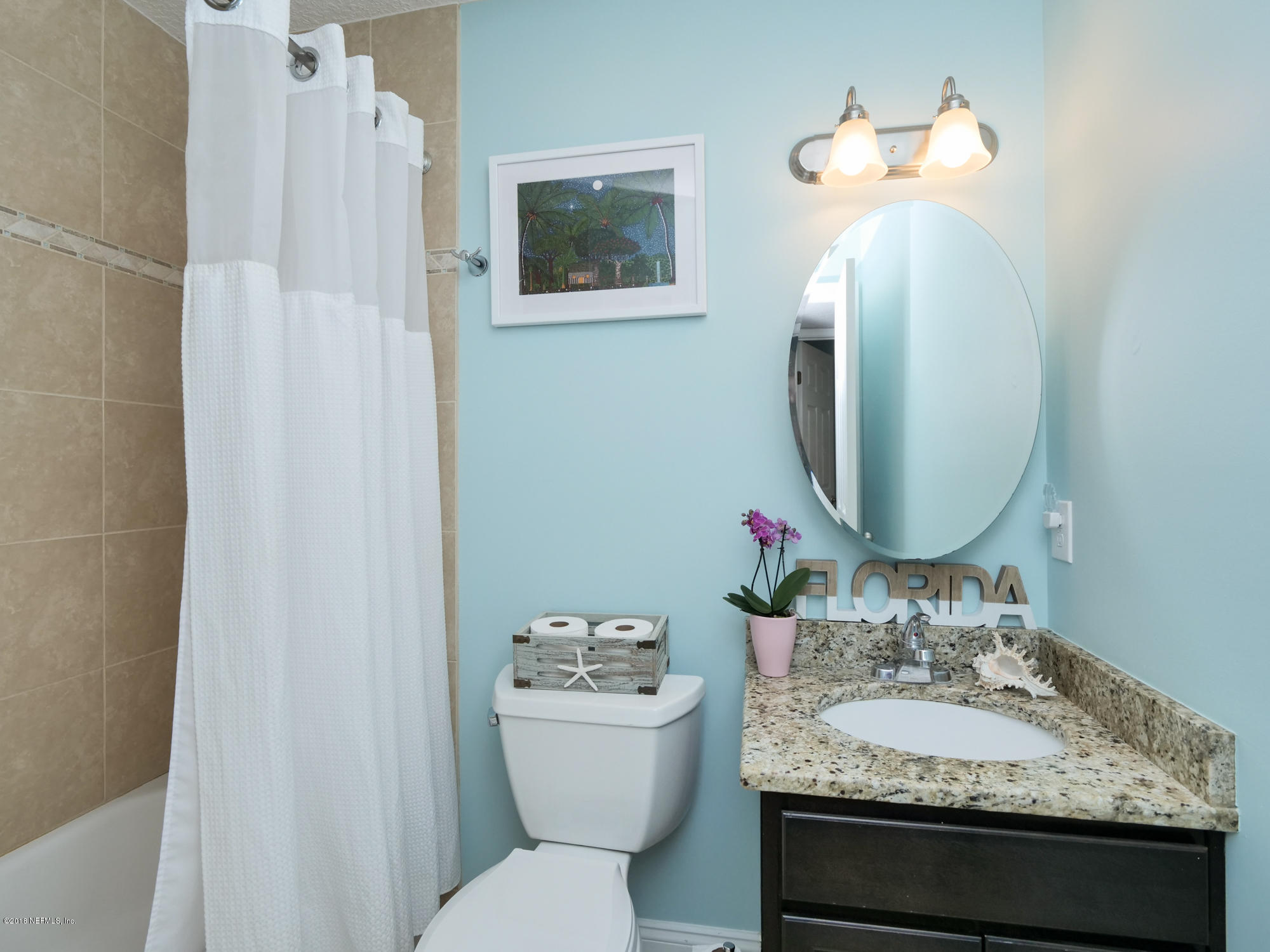 456 Irex Road Atlantic Beach, FL 32233 - Photo 18 of 29 a bathroom with a granite countertop sink toilet and a mirror