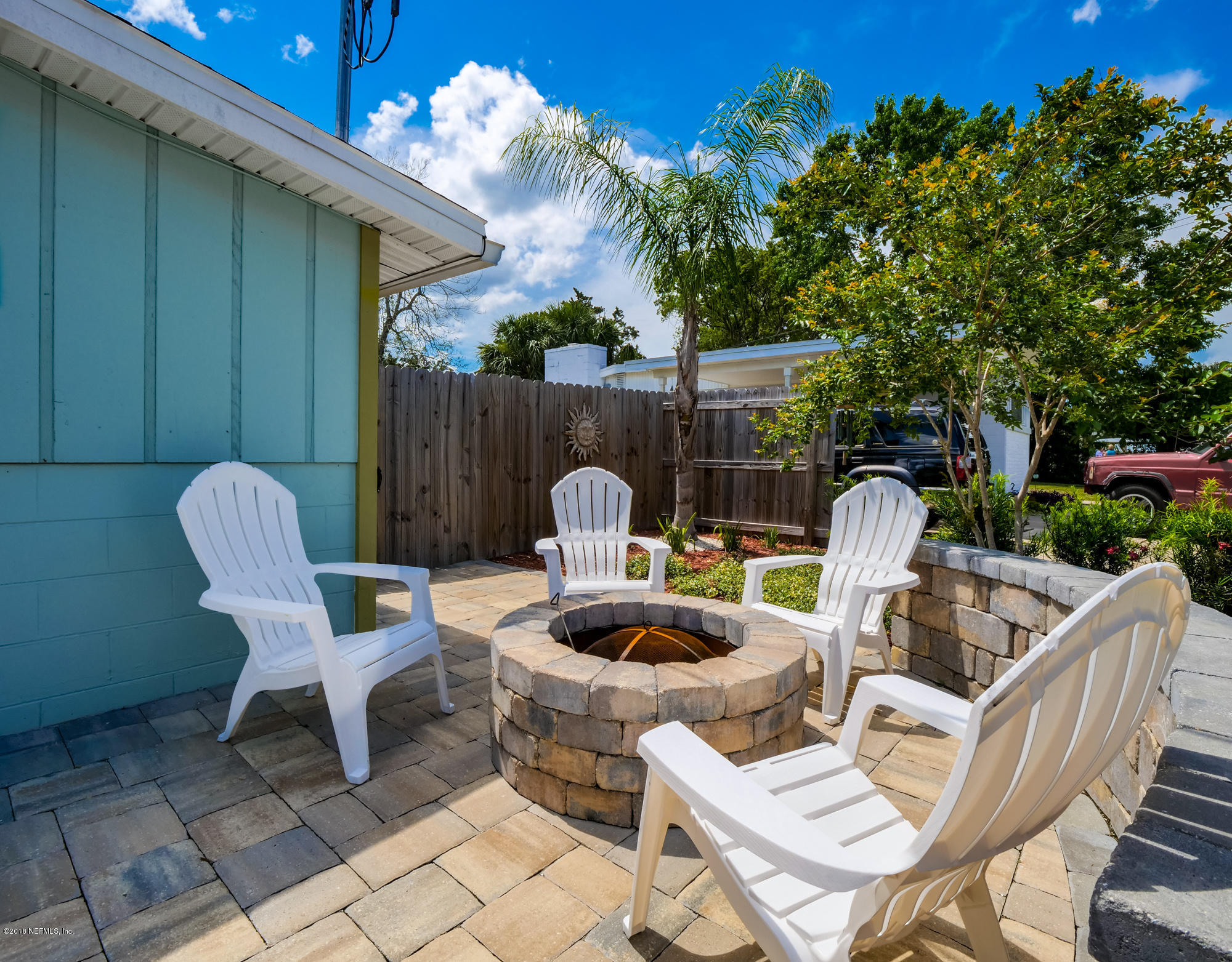 456 Irex Road Atlantic Beach, FL 32233 - Photo 3 of 29 a view of a patio with a table chairs and a fire pit