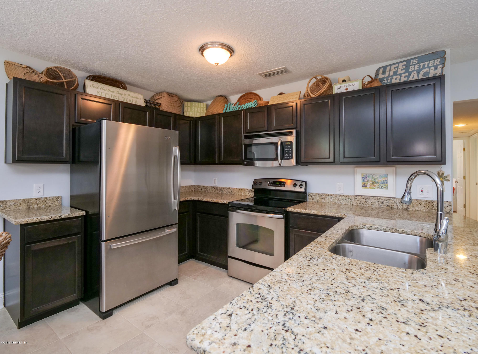 456 Irex Road Atlantic Beach, FL 32233 - Photo 4 of 29 a kitchen with granite countertop a refrigerator stove and sink