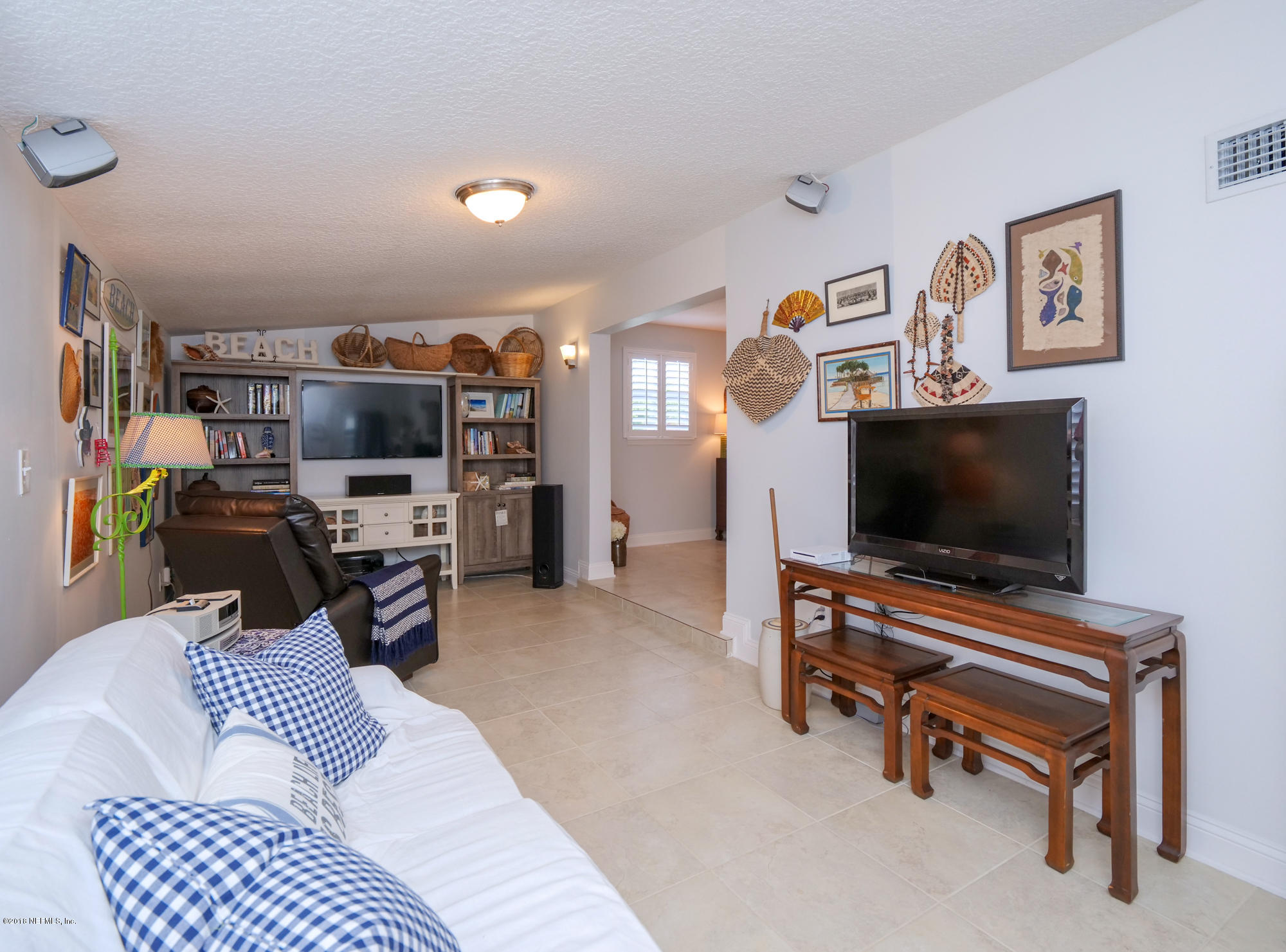 456 Irex Road Atlantic Beach, FL 32233 - Photo 7 of 29 a living room with furniture and a flat screen tv
