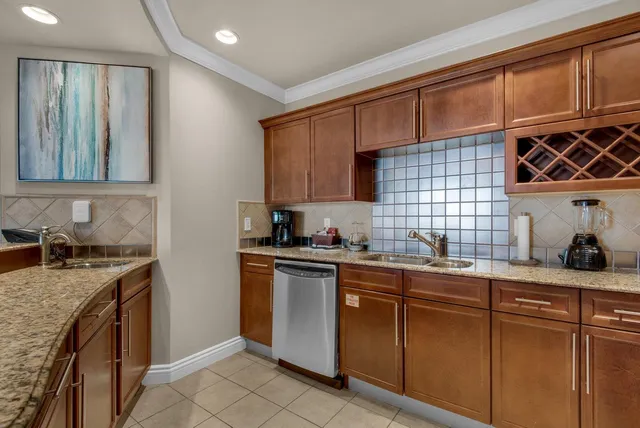 a kitchen with stainless steel appliances granite countertop a sink stove and cabinets