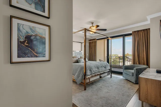 a bedroom with a bed couch and a large window