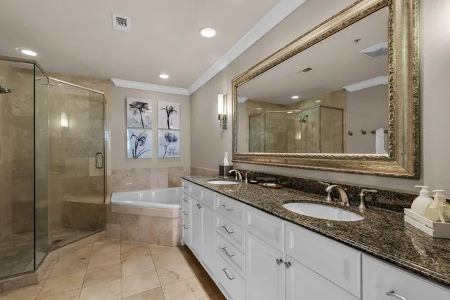 a bathroom with a granite countertop sink mirror and shower